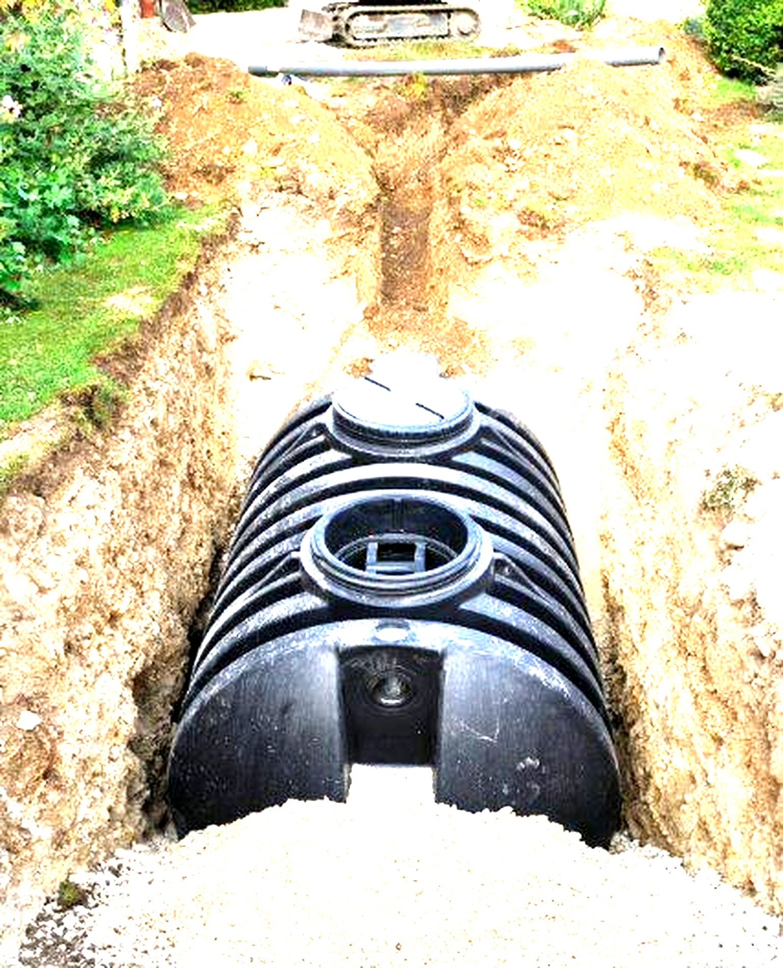 New septic tank being installed in an excavated trench in Troutman, NC